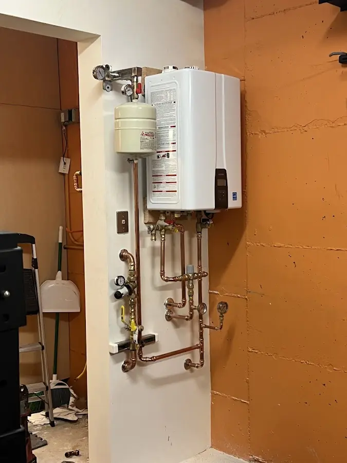 Plumbing technician inspecting water heater connections in Cordele